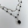 Swirl black sun necklace