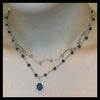 Swirl black sun necklace